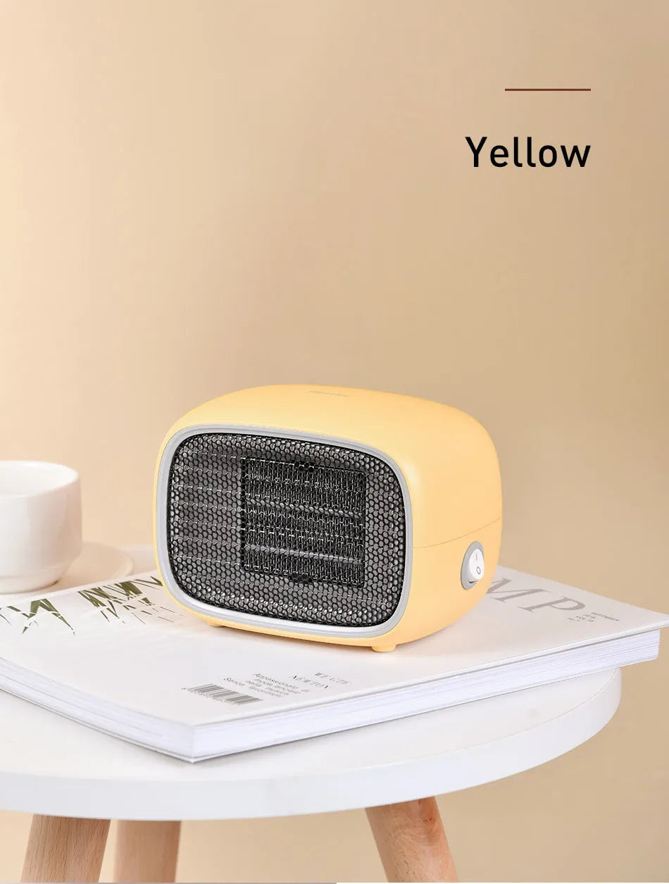 Green mini ceramic space heater with EU plug on a wooden desk