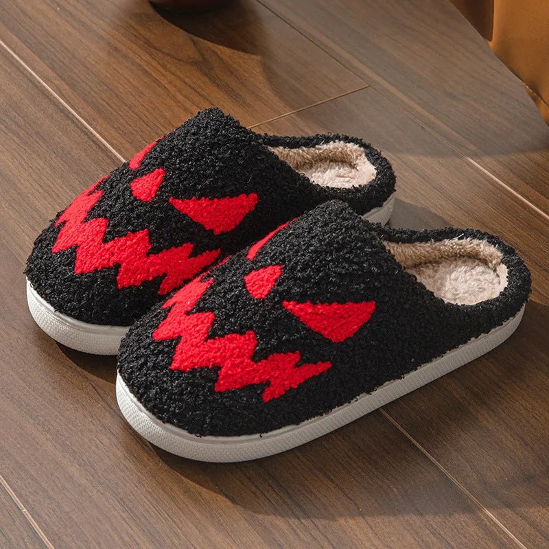Halloween couple slippers with black and orange ghost face embroidery on suede upper and PVC sole.