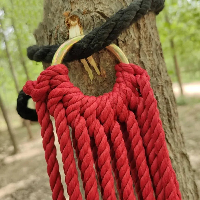 Outdoor nylon rope mesh hammock hanging between trees showing mesh construction and tying ropes