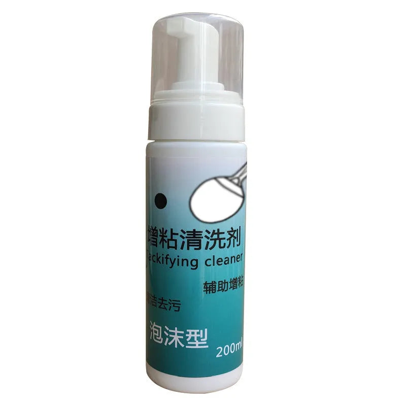 Table tennis racket cleaner kit with sponge mop, rubber cleaning agent bottle and protective film on table