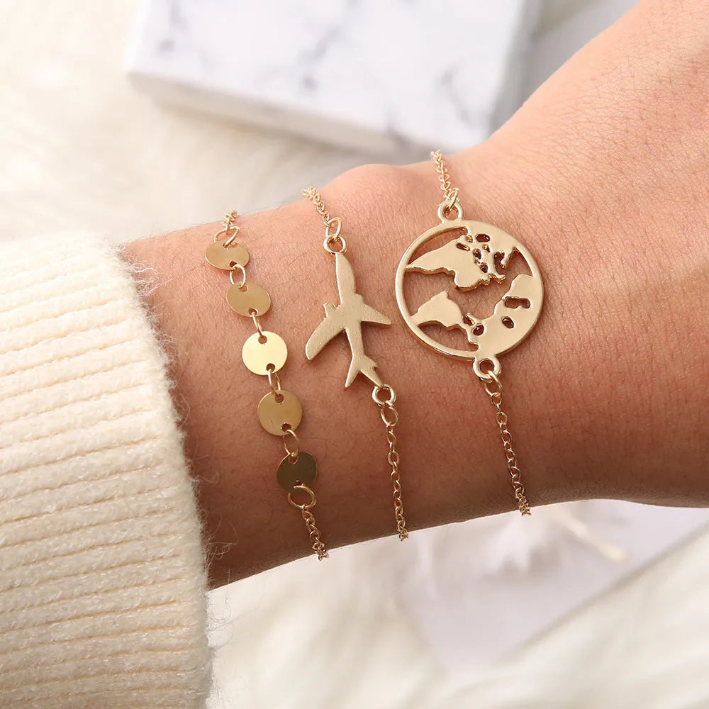 Set of three women's bohemian-style bracelets with alloy heart charms featuring detailed aircraft map designs.