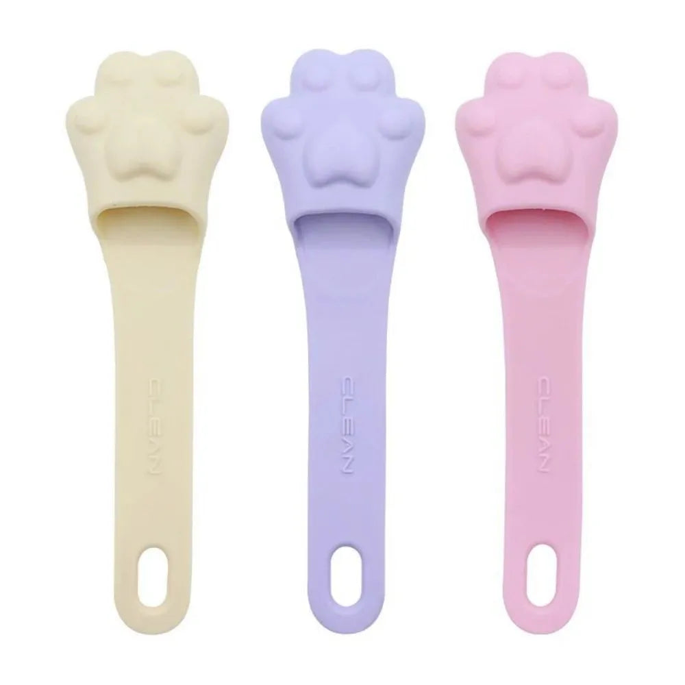 Silicone finger cover toothbrush for pet dental cleaning in pink, purple, and yellow colours.