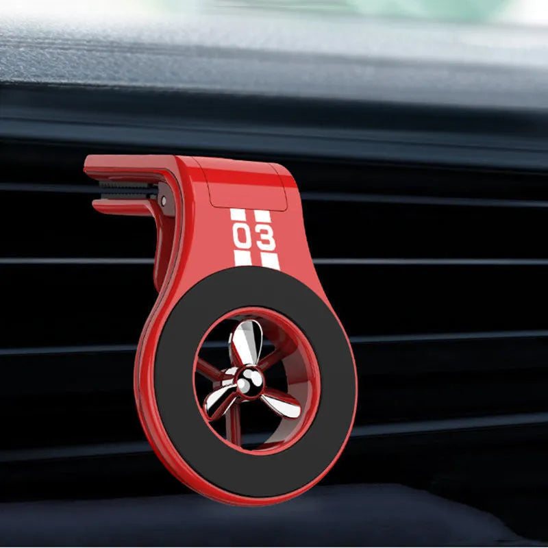 Magnetic car phone holder with fragrance diffuser clipped to car air vent