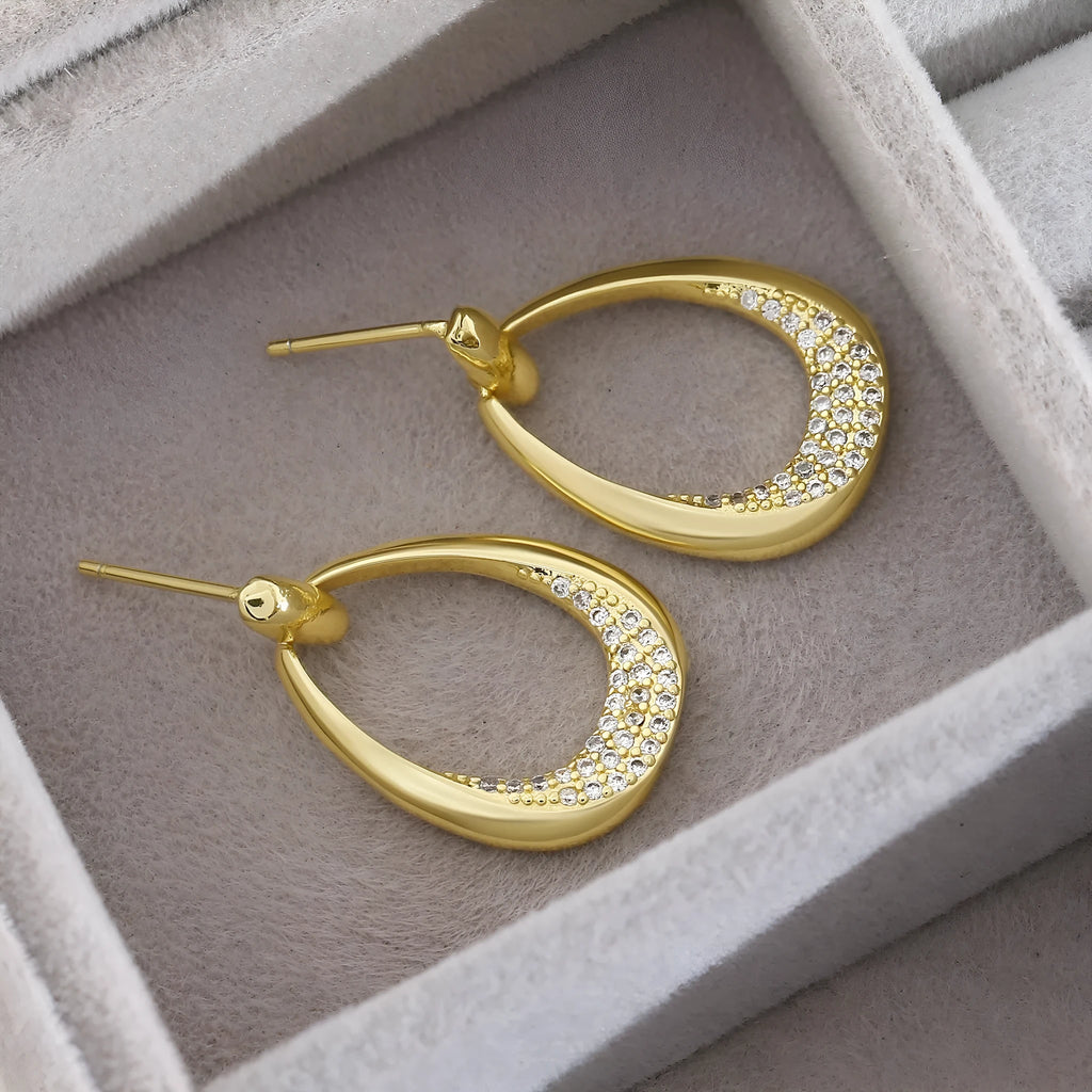 Women's yellow gold geometric drop earrings with ring and oval elements measuring 2.6 by 1.7 cm