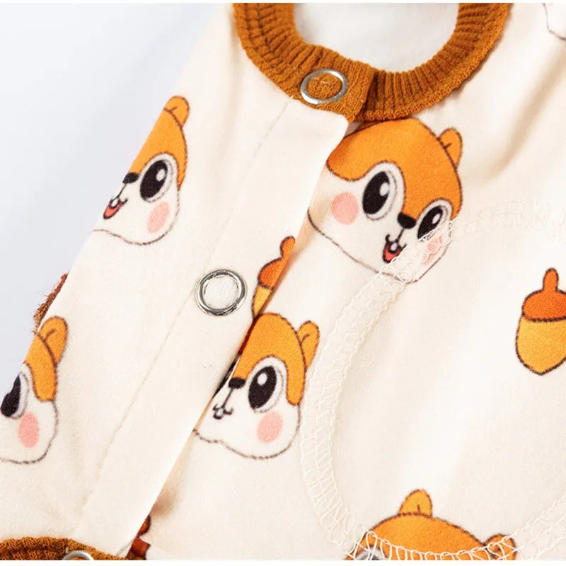 Chip 'n' Dale sleeveless dog jumpsuit with squirrel and acorn print, fuzzy embroidered acorn pocket, ribbed cuffs and snap closure, cream or white.