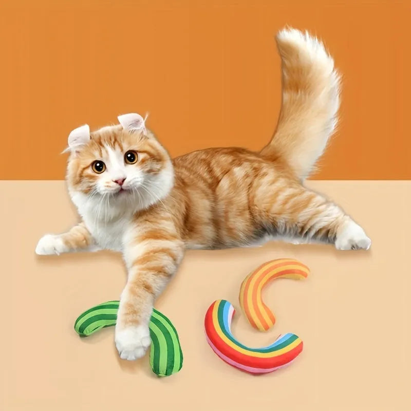 Set of cat toys including a noise maker with catnip and a green, rainbow, or yellow striped pillow.