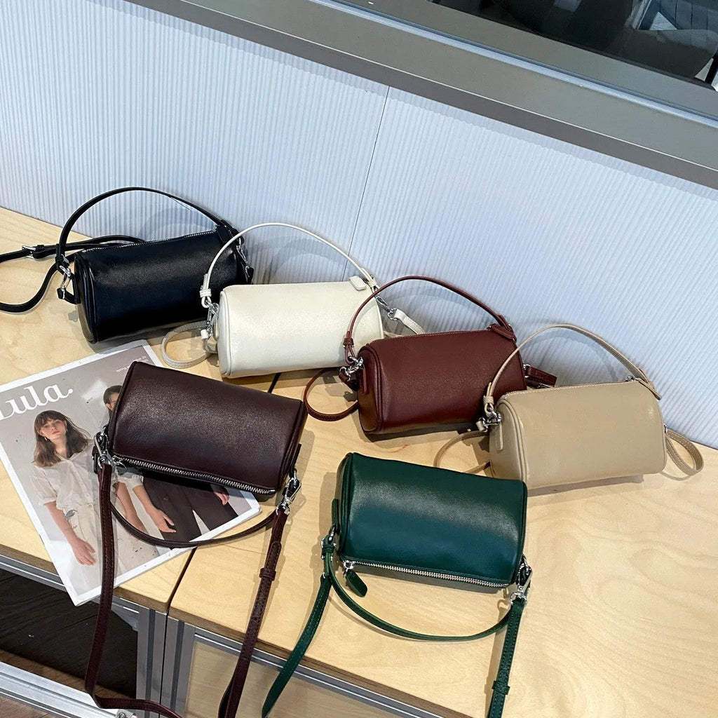 Soft vegetable tanning leather cylindrical crossbody phone bag in six colour options on a white background.