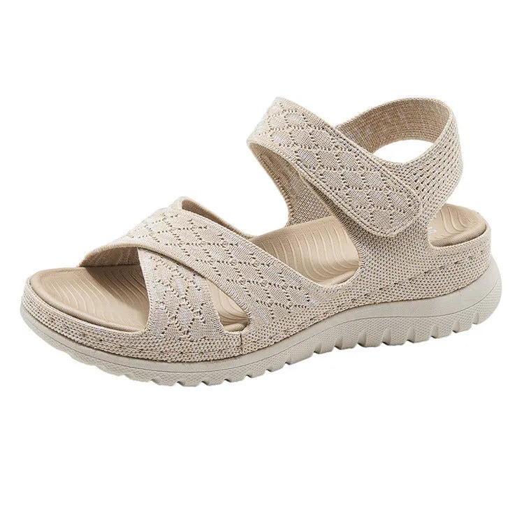 Plus size flat sandals in apricot with Flyknit upper, PVC sole, and Velcro strap.