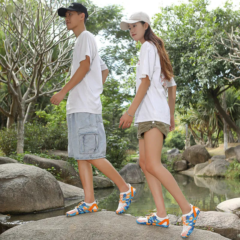 A pair of quick-drying lace-up beach shoes in a mesh material with a rubber non-slip sole.