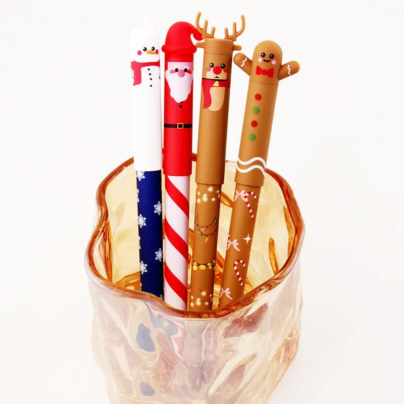 Four Christmas-themed erasable gel pens with Santa, gingerbread man, elk, and snowman designs on a white background