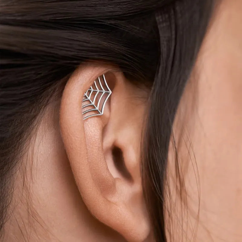 Spider web geometric mesh design stud earrings in gold and silver electroplated finishes.