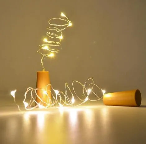 Silver copper wire LED string light with bottle stopper for decorative lighting.