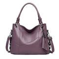 Large capacity PU tassel handbag in black, front view with tassel detail