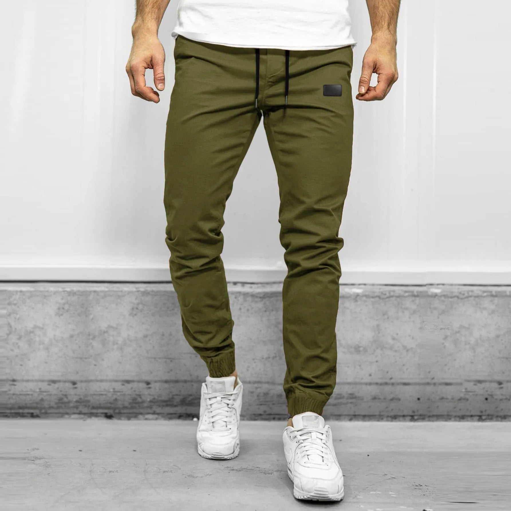 Men's quick-dry loose tapered running trousers in army green, side view on model