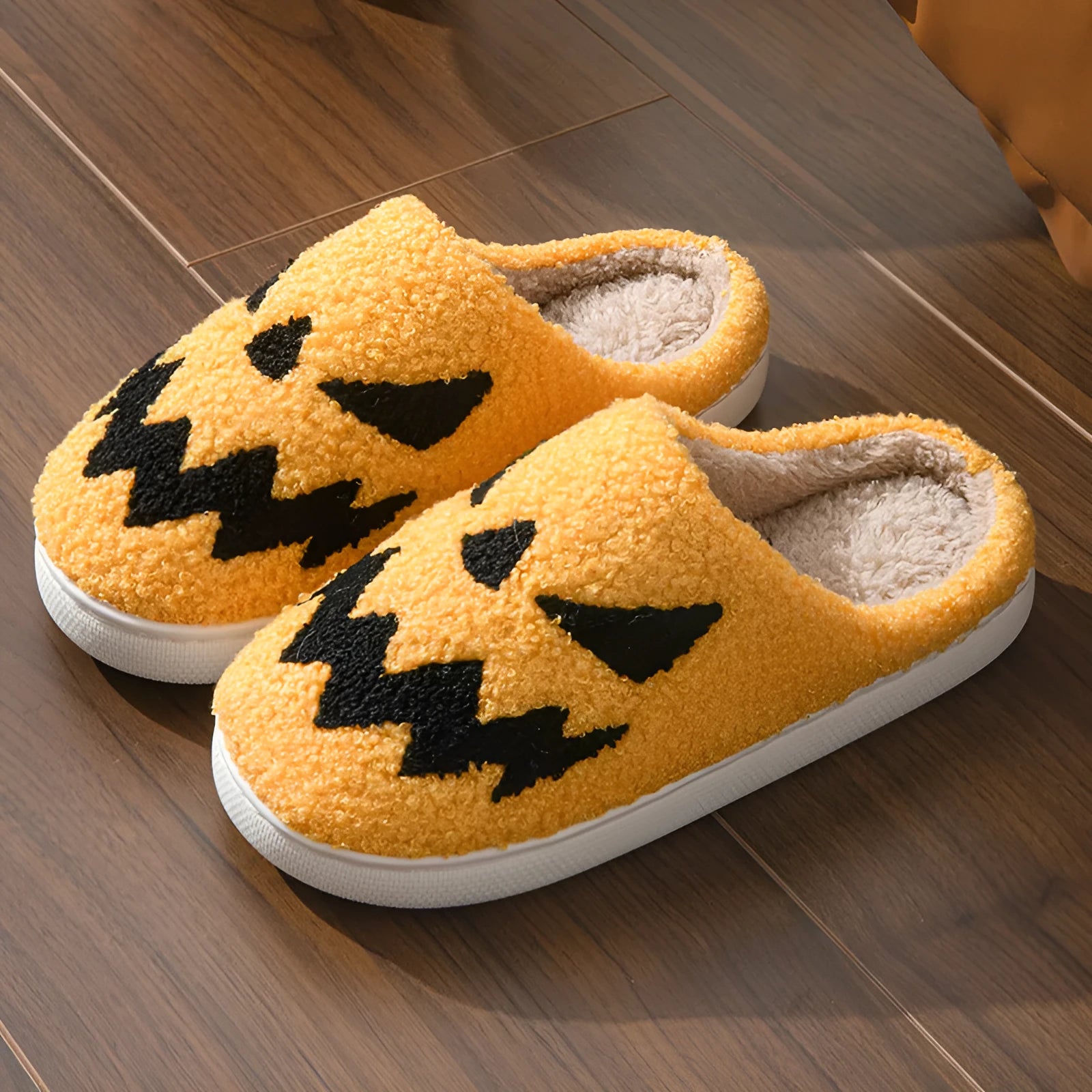 Halloween couple slippers with black and orange ghost face embroidery on suede upper and PVC sole.