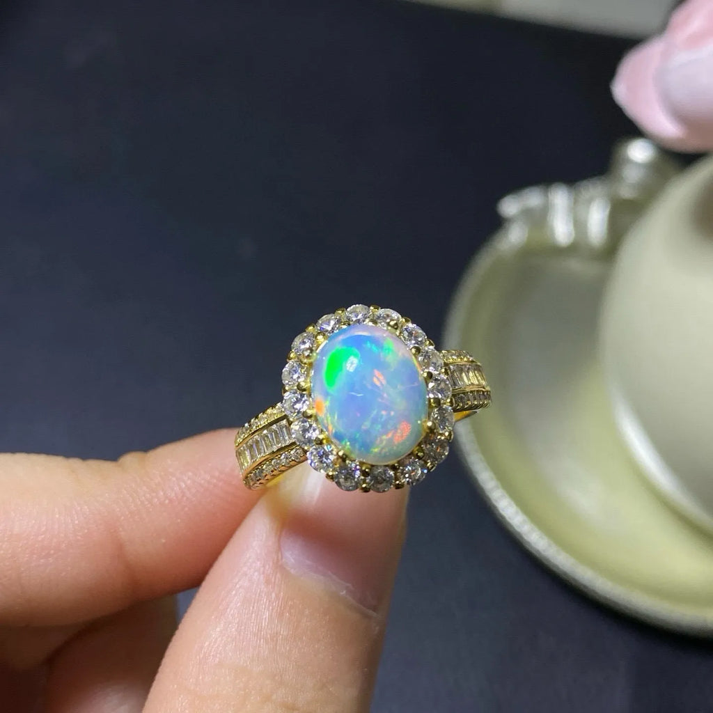 Handmade adjustable silver ring with a natural opal stone in rose gold plating.