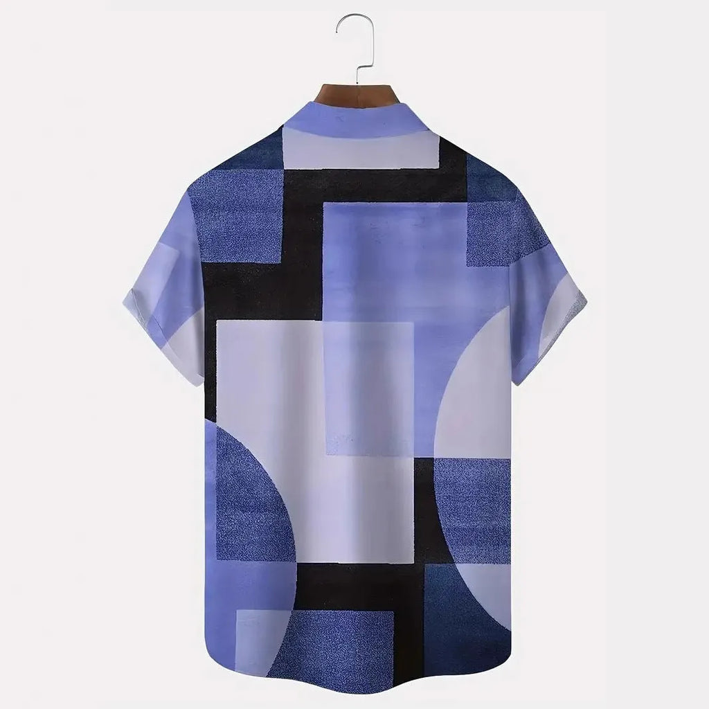 Man wearing a short sleeve cardigan with a blue and white retro geometric square print pattern.