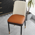 Leather horseshoe-shaped non-slip table cushion in a solid colour on a chair.