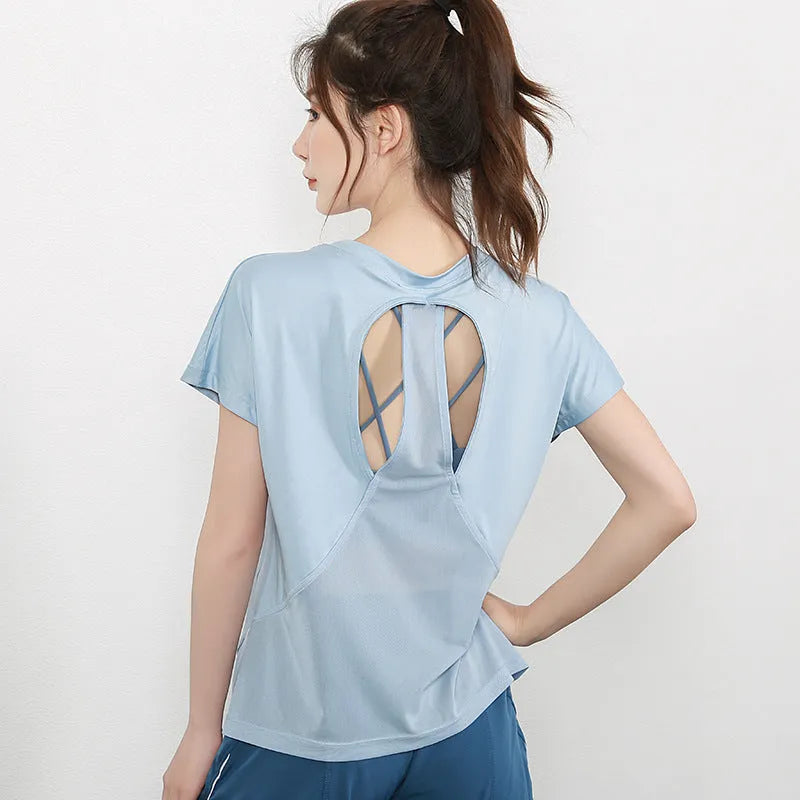 Women's short sleeve polyester sports T-shirt in grey green, shown on a model.