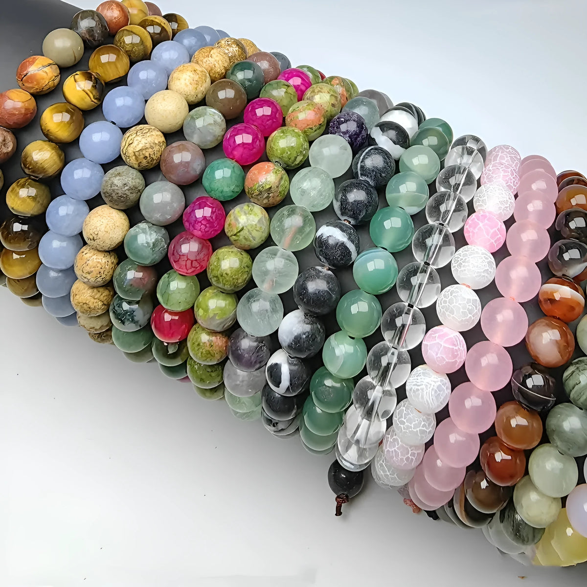 Natural 8mm polished crystal stretch bracelet with amethyst beads on a white background