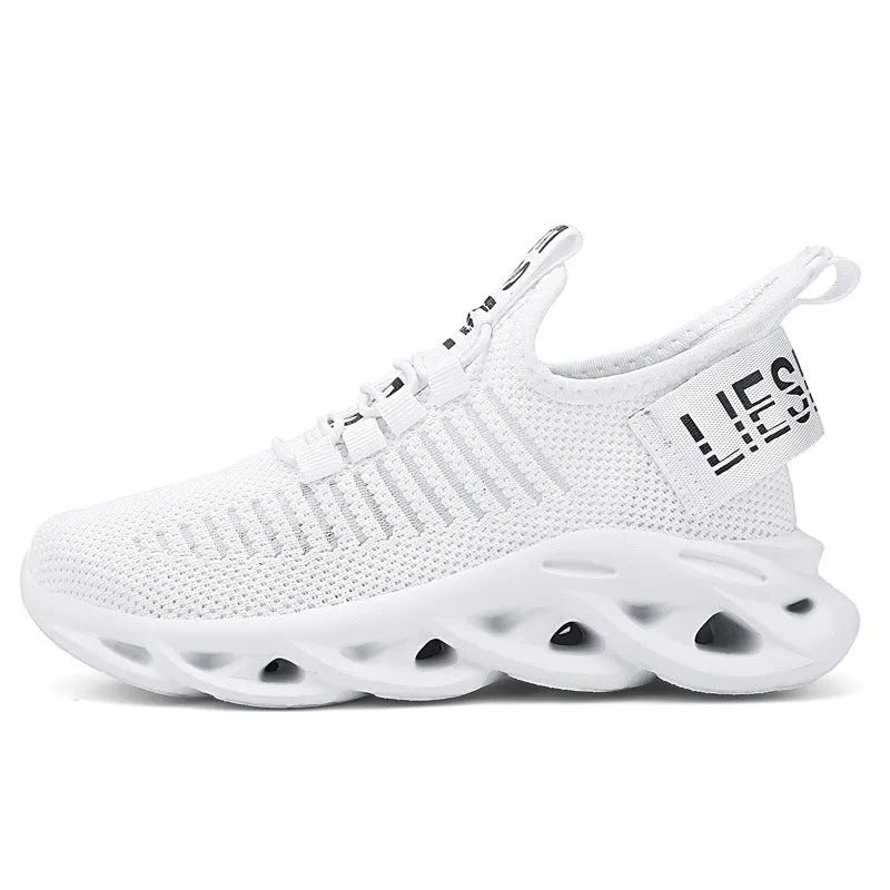 Children's black velcro sneakers with fabric upper and thick EVA sole on a white background.