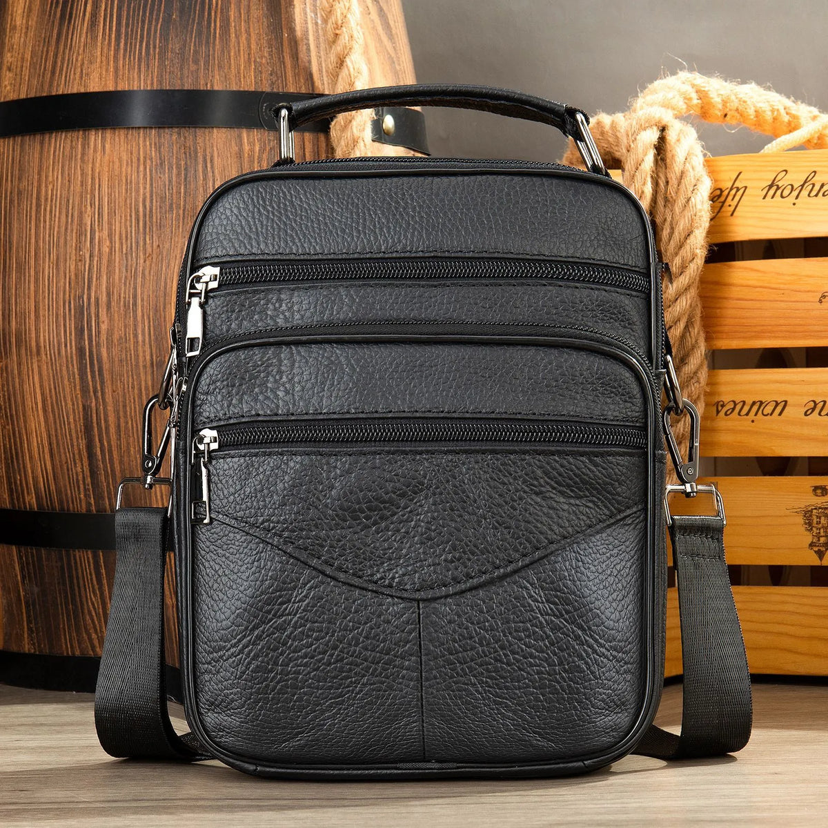 Men's top grain leather crossbody bag in brown with stitching detail and expandable side panels