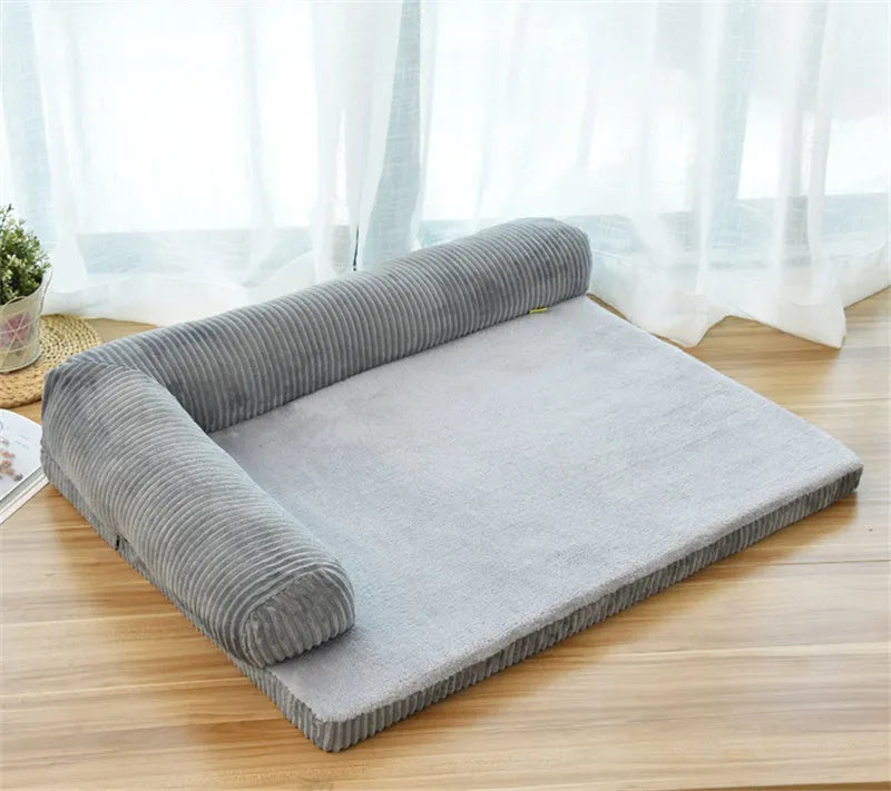 Corduroy pet sofa dog bed in grey with raised sides on a wooden floor