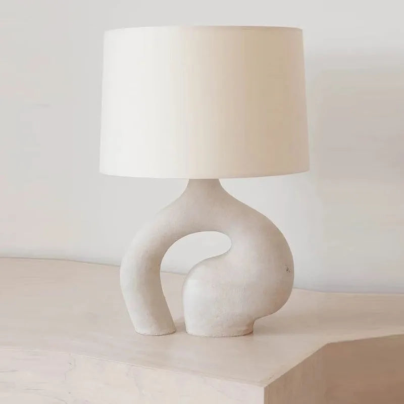 Modern minimalist table lamp with Nordic fabric shade on a bedside table