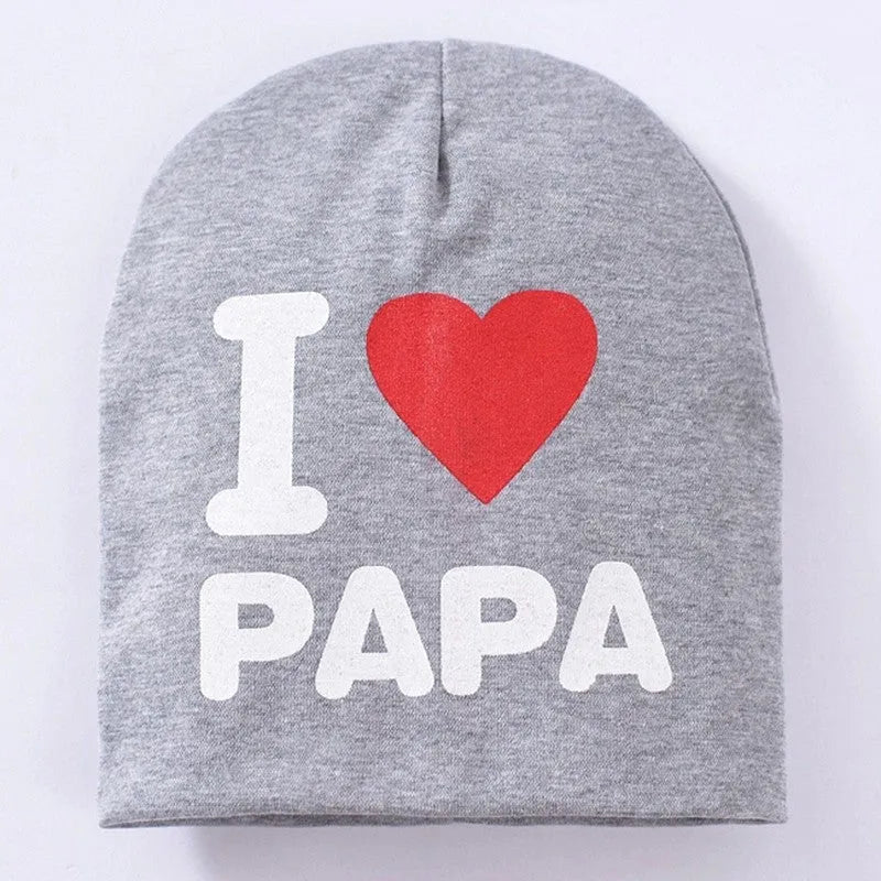 Baby winter hat in grey with 'Love Mama' embroidery, laid flat showing its 20cm height.