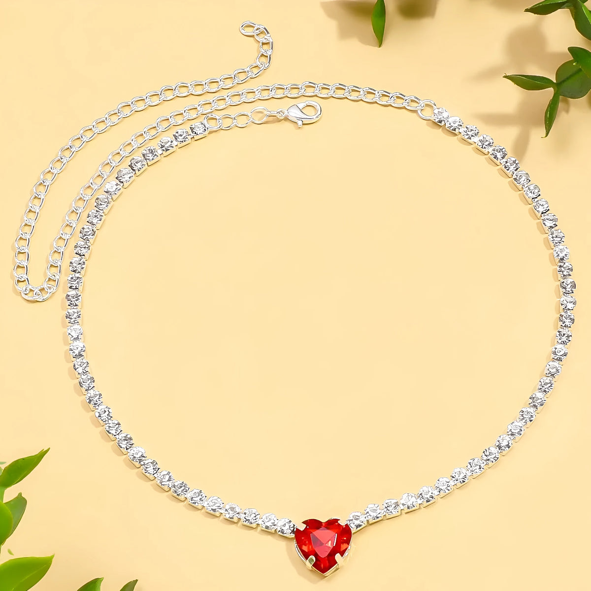 Heart pendant necklace with rhinestone crystal on a 41-50cm box chain, available in gold or silver finish.