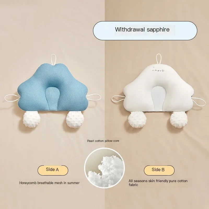 Blue and white U-shaped baby head shaping pillow made of pure cotton on a neutral background.