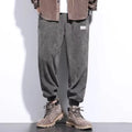 Men's grey ankle-tie sweatpants with a straight leg on a plain background