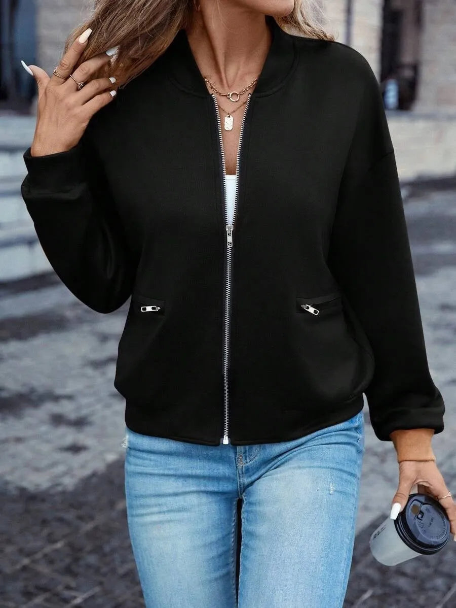 Black women's casual zip jacket with long sleeves on a hanger.