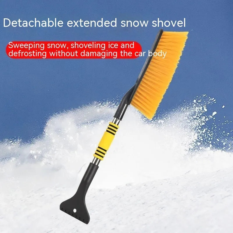 Yellow telescopic long-handled car snow brush and ice scraper on a snowy car windscreen.