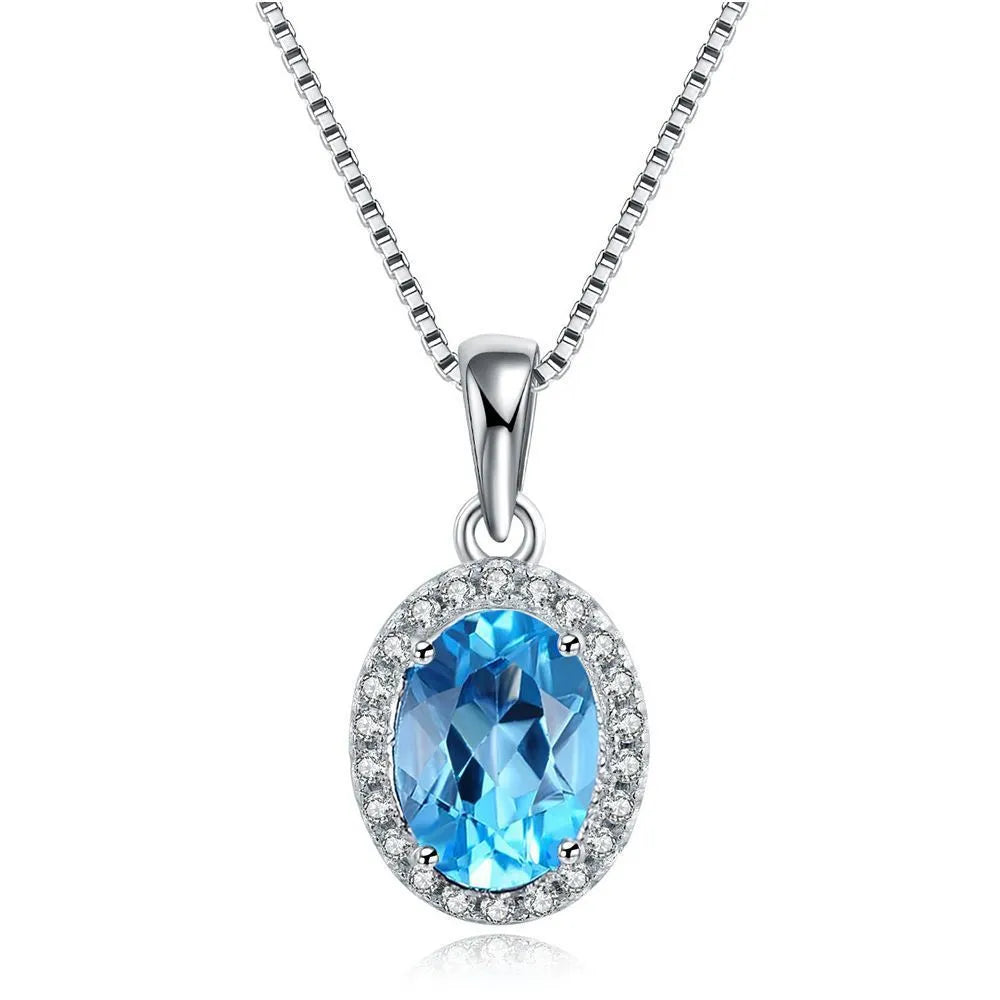 925 sterling silver jewellery set with blue topaz stones showing earrings, ring, pendant and necklace in geometric design