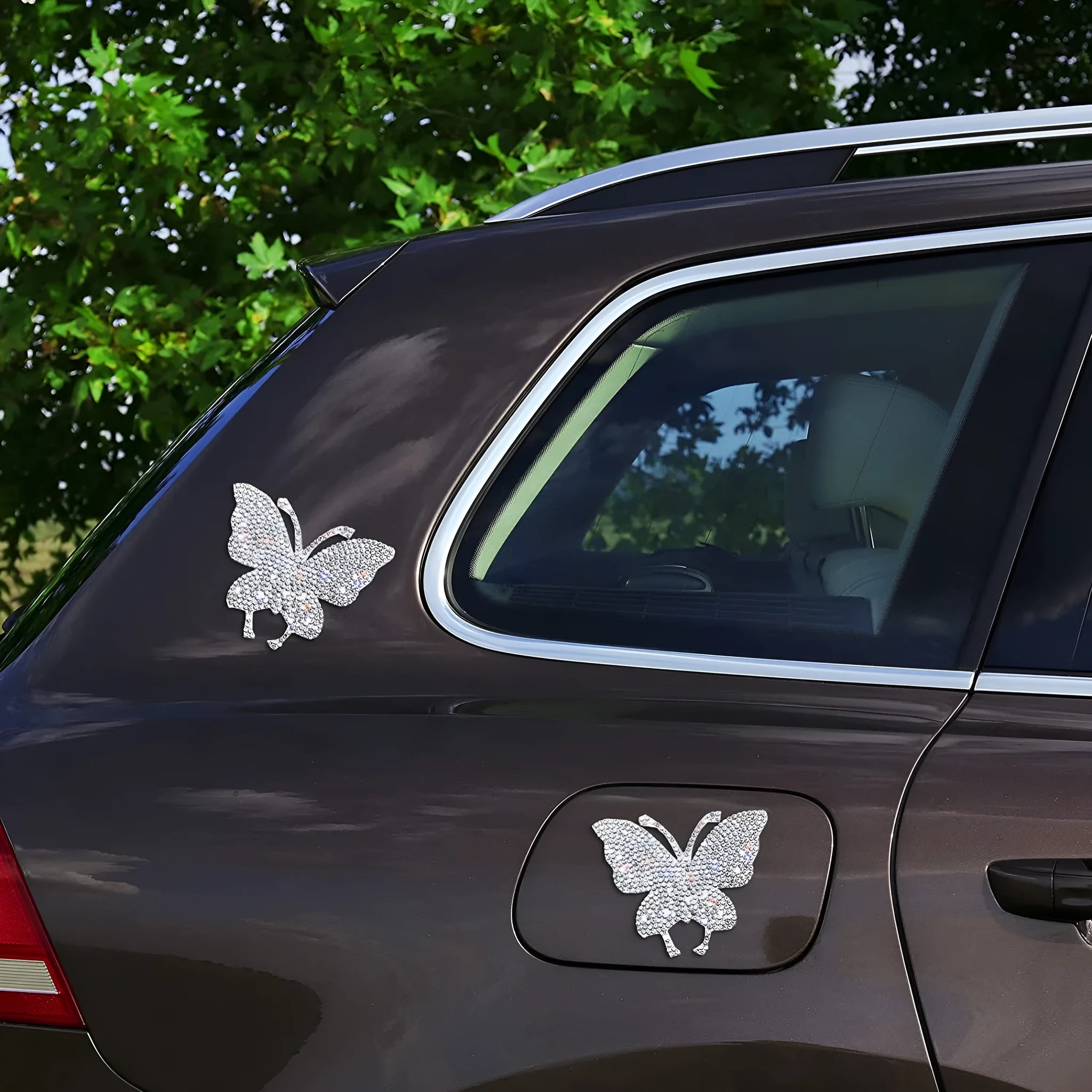 Glass car sticker with diamond-encrusted bear paw or butterfly design on white background.