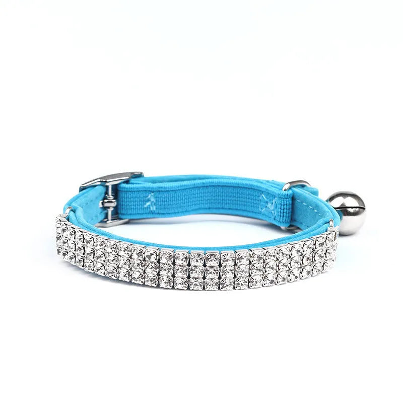 Red velvet cat collar with rhinestones, adjustable buckle, shown on a white background.