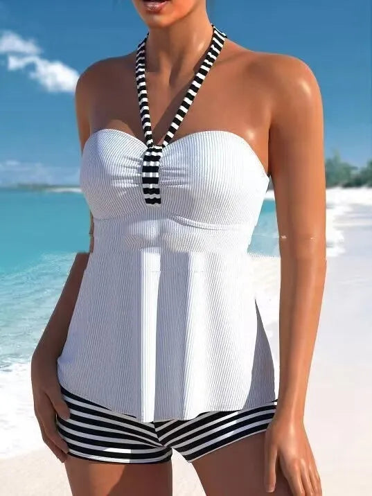 Women's off-shoulder swimsuit with solid colour top and black and white striped briefs