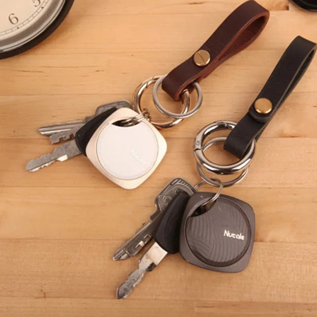 Compact Bluetooth tracker key finder with aluminium alloy shell and button, shown in black