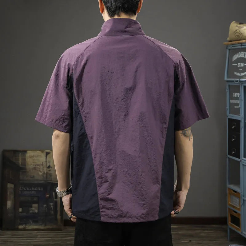 A brown men's loose-fit short-sleeve shirt with a half-zip front and stand collar.
