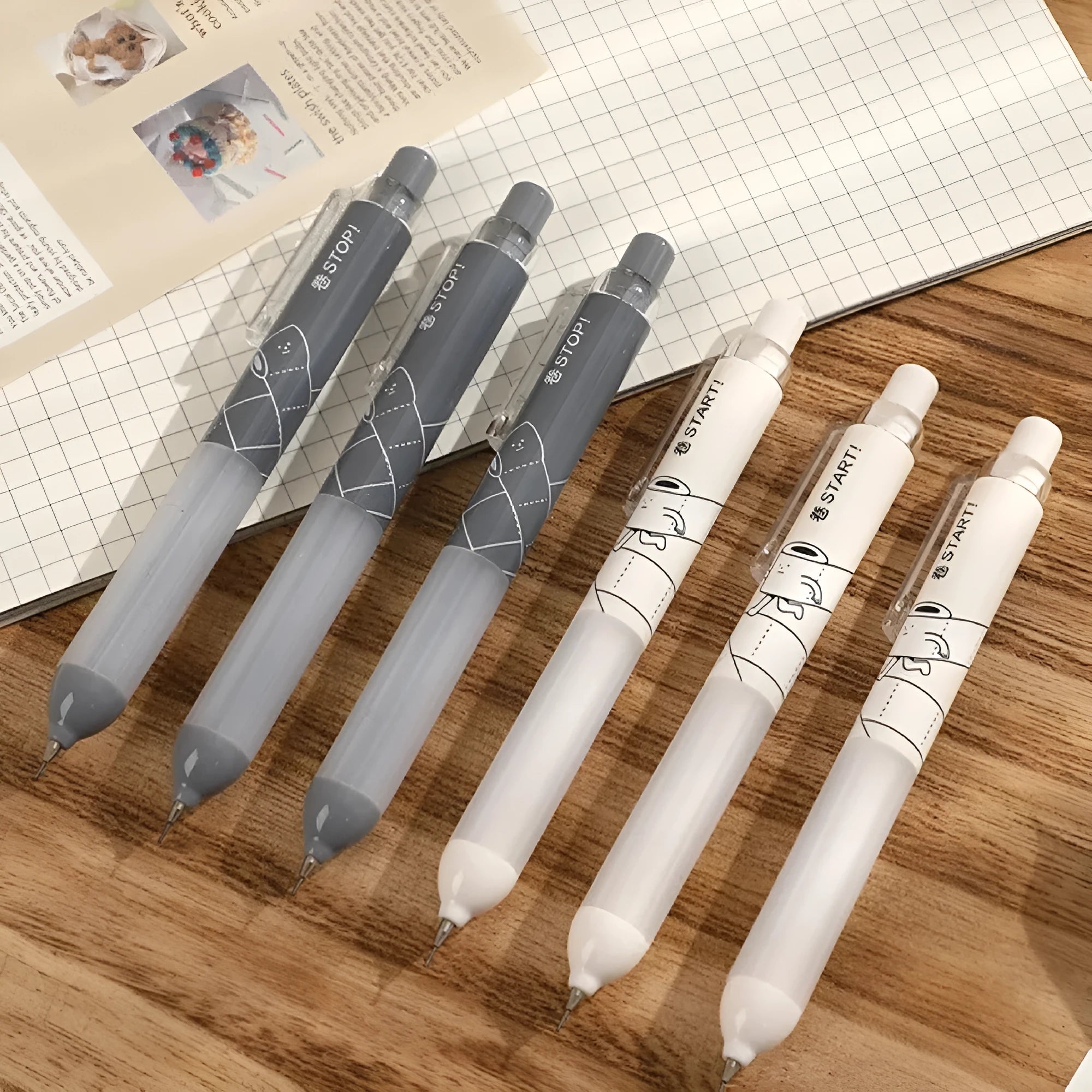 Black and white 0.5mm automatic pencils with cloud grip plastic holders on minimalist background