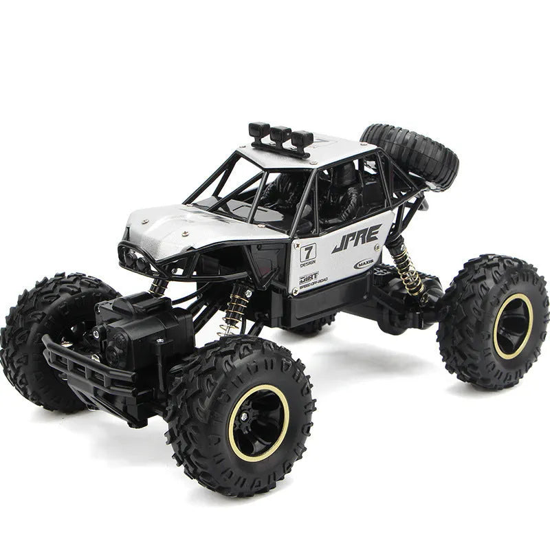 Large black 4WD remote control off-road climbing car on a rocky surface.