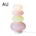 Candy String Rainbow Floor Lamp in creative macaron style with glass shade and iron body on a wooden table