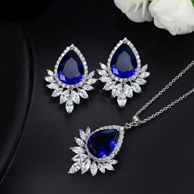Formal jewellery set with chain, pendant, and matching earrings in blue, red, or white colours for bridal banquets.