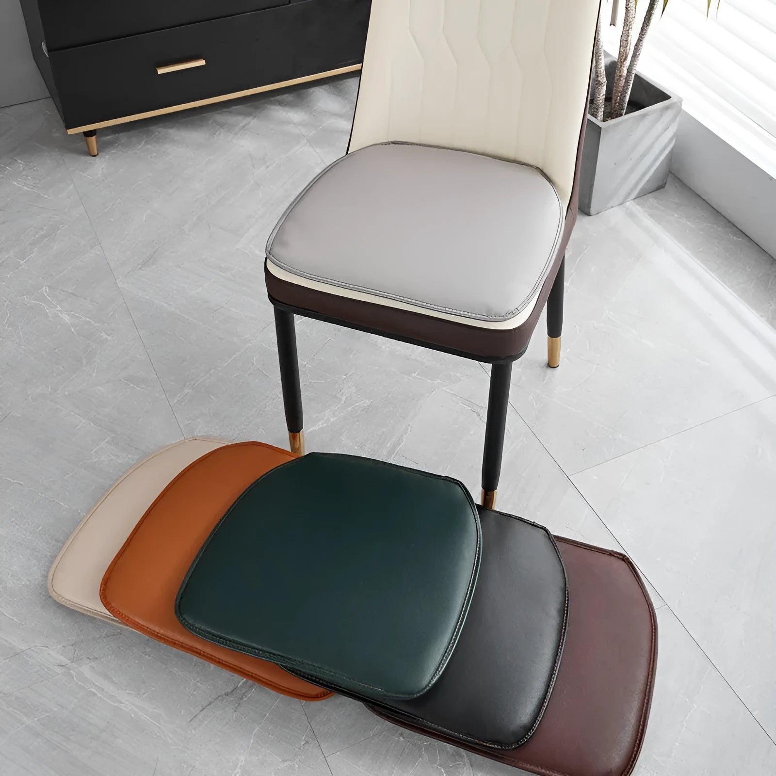 Leather horseshoe-shaped non-slip table cushion in a solid colour on a chair.