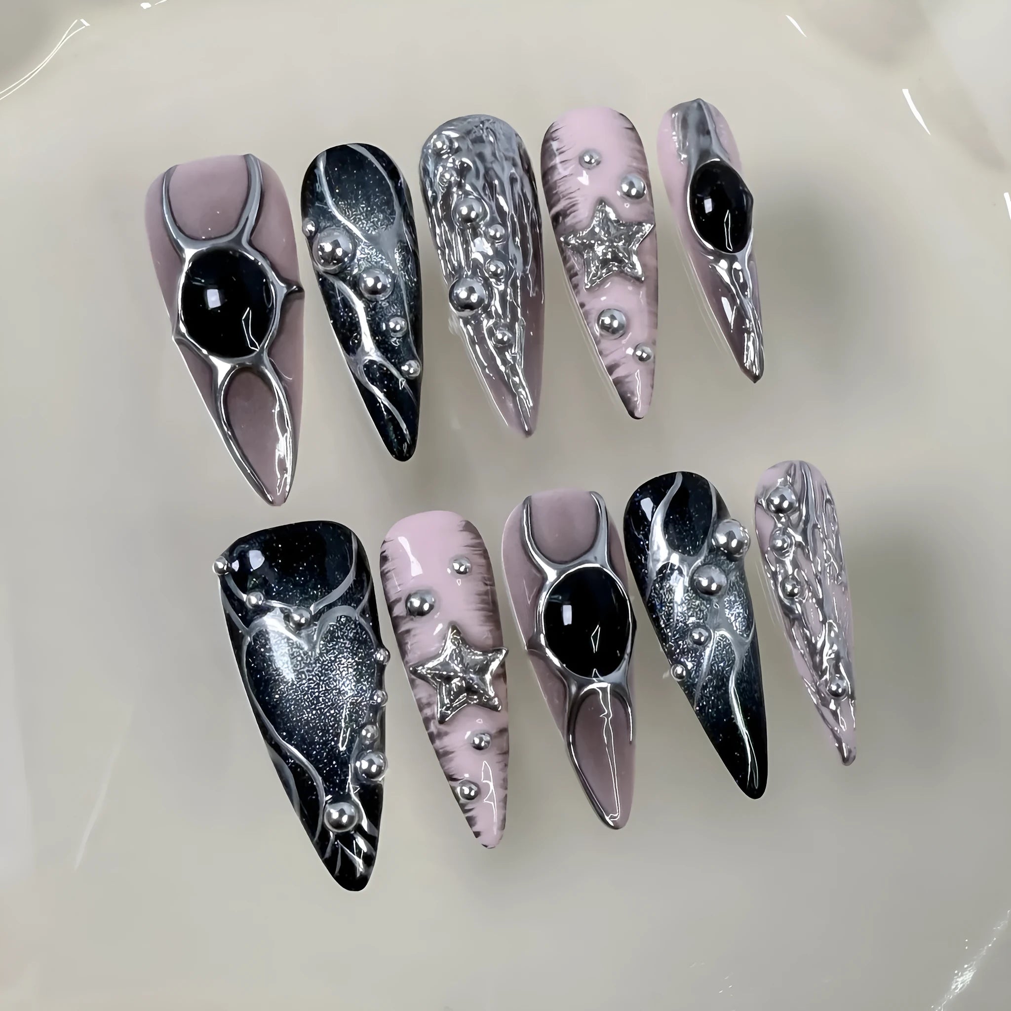 Set of long pointed dyed nails with metal hand-painted relief and cat eye finish in multiple sizes