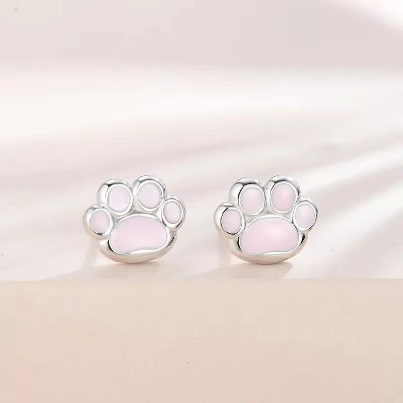 Handmade 925 silver cat paw ear studs in white gold colour finish on a white surface