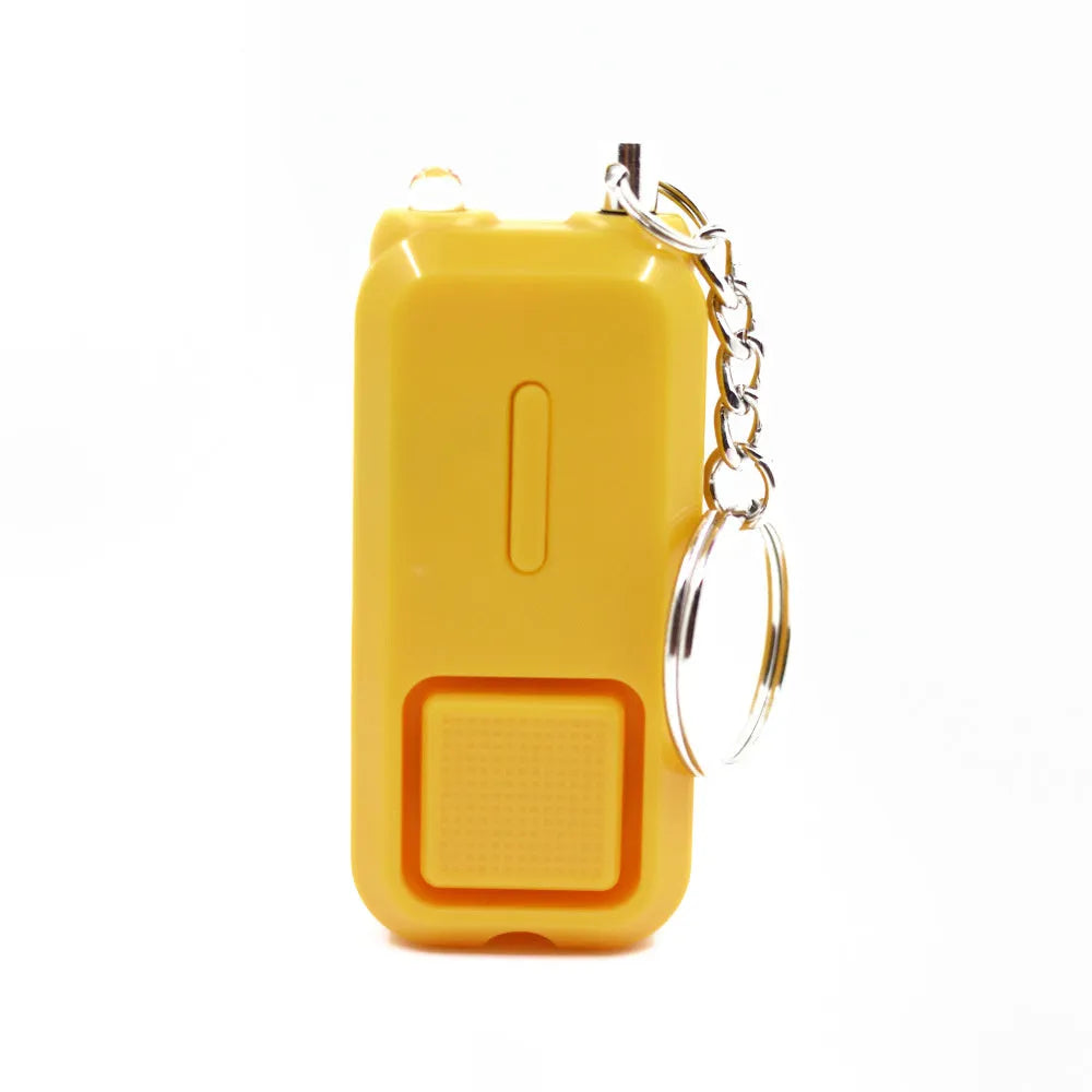 Compact pink personal safety alarm keyring with a button, shown next to its white retail box.