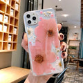 Floral TPU iPhone case with large pink and yellow flower patterns on back cover.