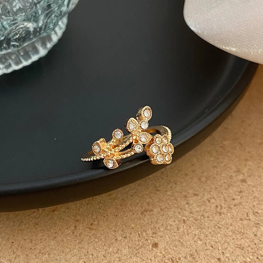 Women's diamond flower leaves open ring in gold and white colour options showing floral design